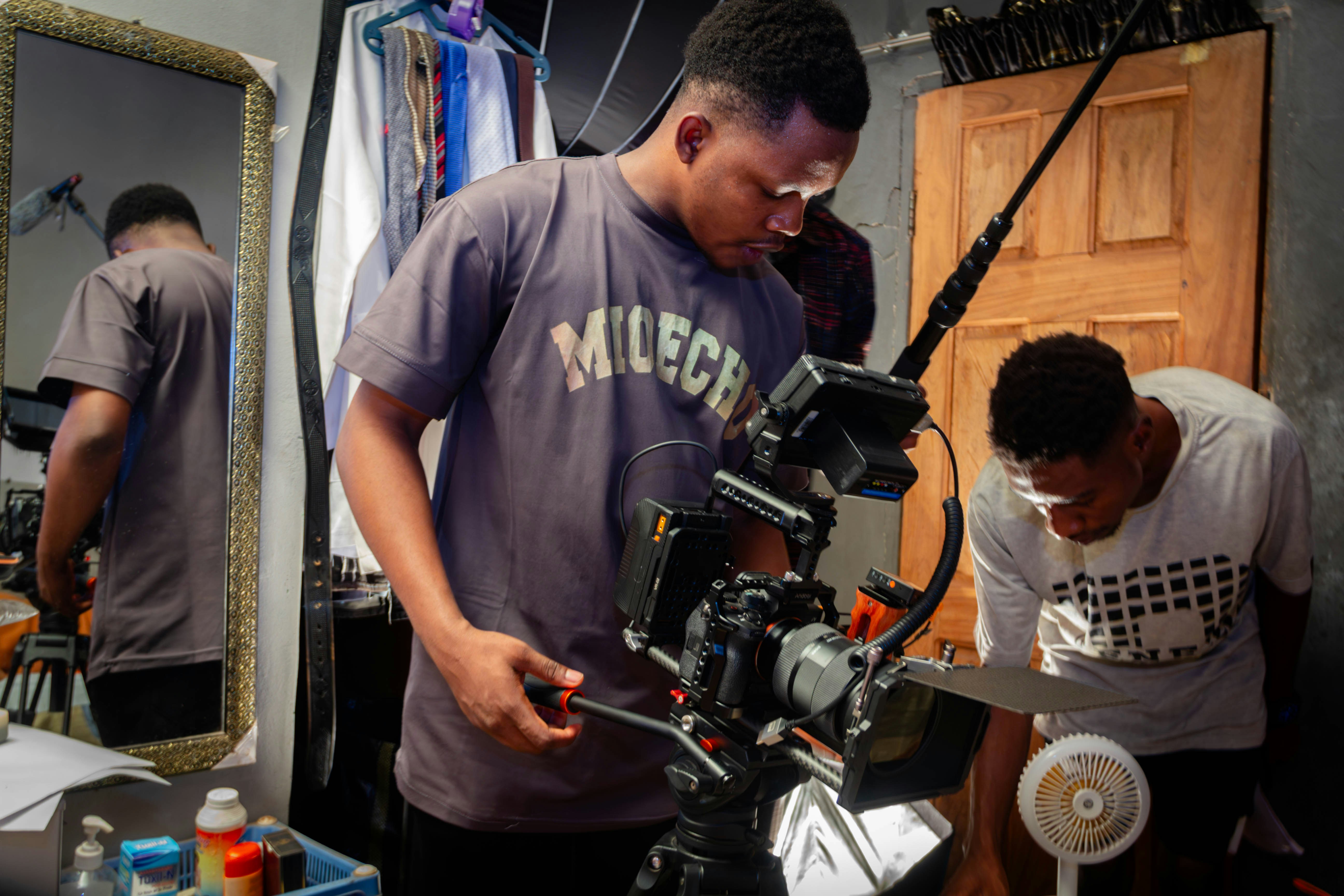 Filmmakers operating professional video equipment on set.